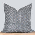 Decorative pillow with a blue and brown pattern on a light gray background